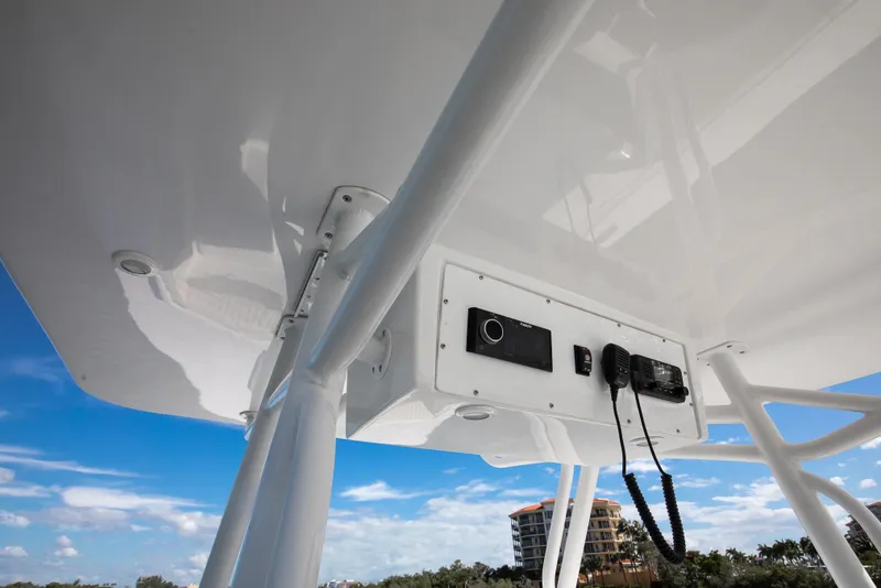 Slide: The Image of 1997 Marlago 35fs boat console with radio equipment, under clear blue sky. - 6