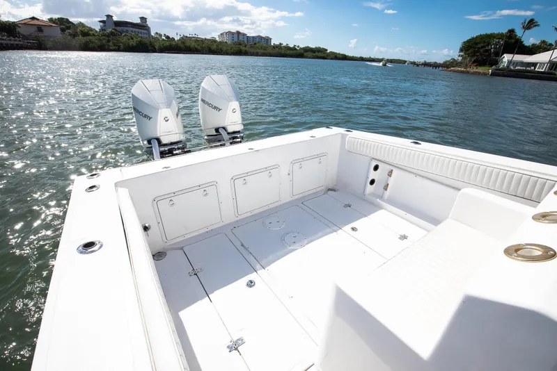 Slide: The Image of 1997 Marlago 35fs boat with twin Mercury engines on a sunny waterway. - 9