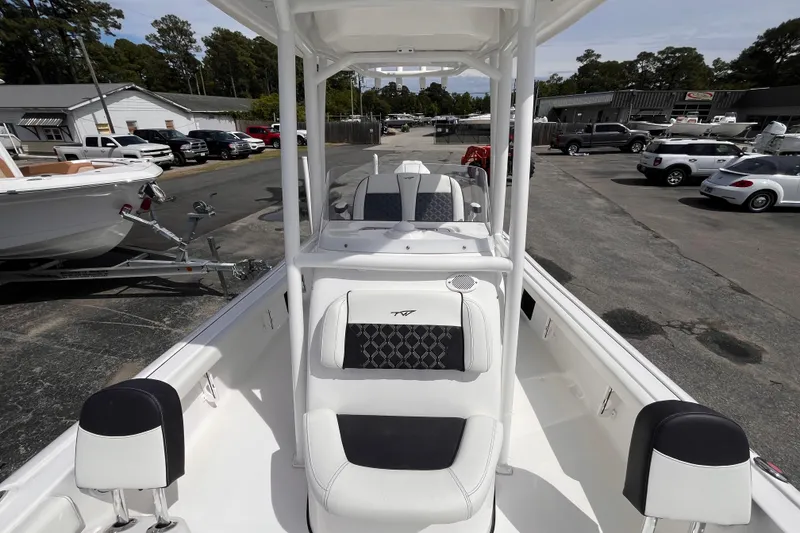 Slide: The Image of 2026 Tidewater 2300 Carolina Bay boat with sleek seating and modern design in a dealership lot. - 12