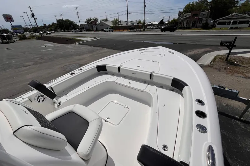 Slide: The Image of 2026 Tidewater 2300 Carolina Bay boat, white interior, parked near a road. - 13