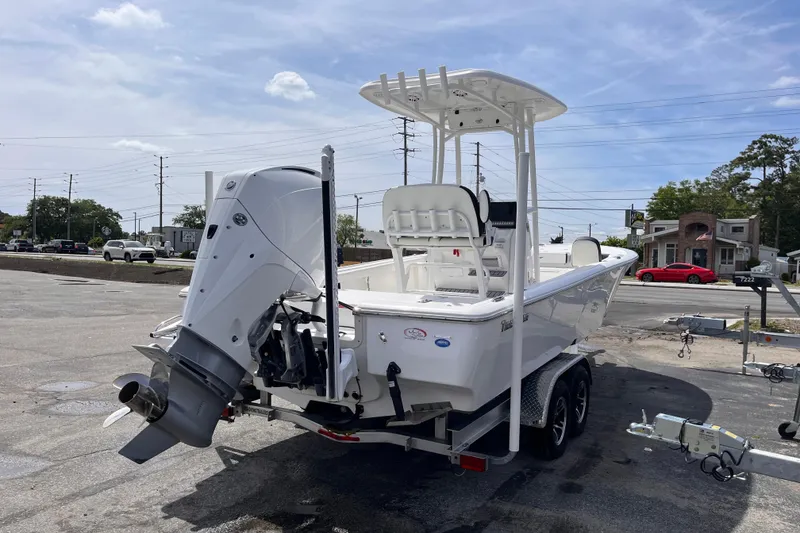 Slide: The Image of 2026 Tidewater 2300 Carolina Bay boat on trailer, parked outdoors under a clear sky. - 4