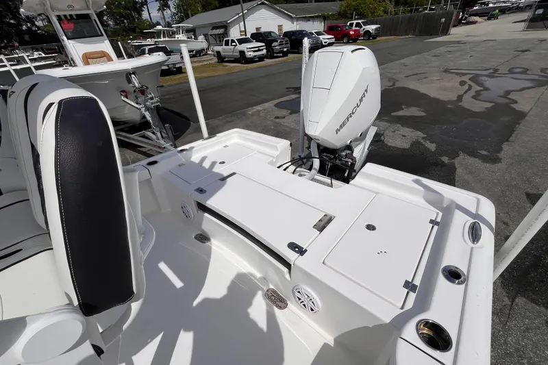 Slide: The Image of 2026 Tidewater 2300 Carolina Bay boat with Mercury engine, parked outdoors. - 5