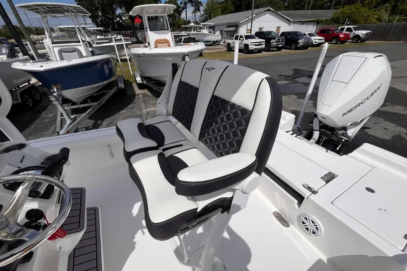 Slide: The Image of 2026 Tidewater 2300 Carolina Bay boat interior with Mercury engine, featuring stylish seating and controls. - 6