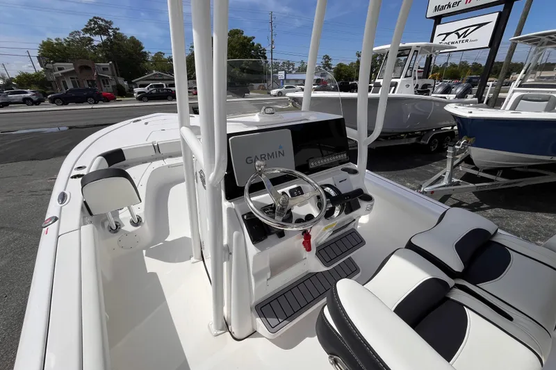 Slide: The Image of 2026 Tidewater 2300 Carolina Bay boat interior with Garmin navigation system and sleek seating. - 7