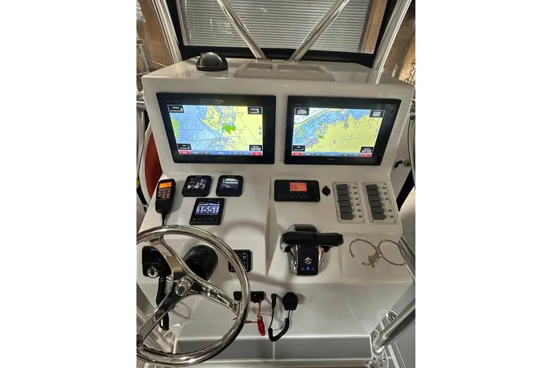 Slide: The Image of Control panel of a 2018 Jersey Cape 31 Little Devil boat with navigation screens. - 6