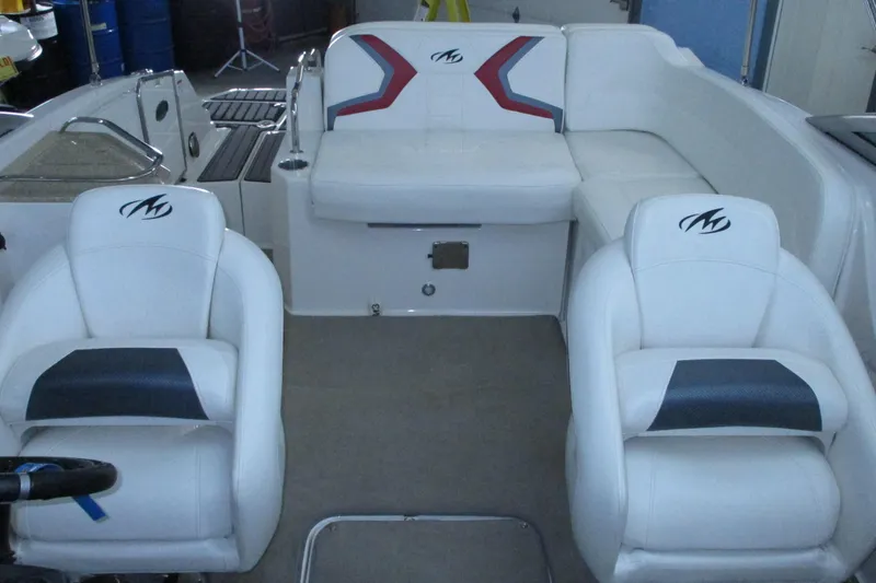 Slide: The Image of Interior of a 2011 Monterey M3 Sport Boat with white seating and logo detailing. - 10