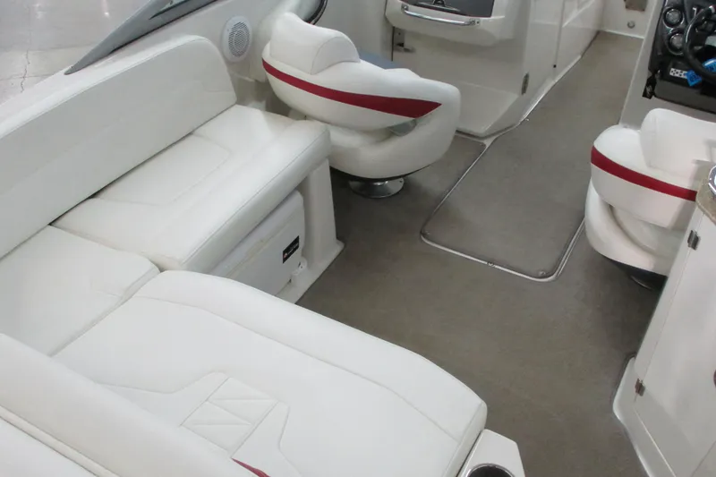 Slide: The Image of Interior of a 2011 Monterey M3 Sport Boat with white seating and red accents. - 3