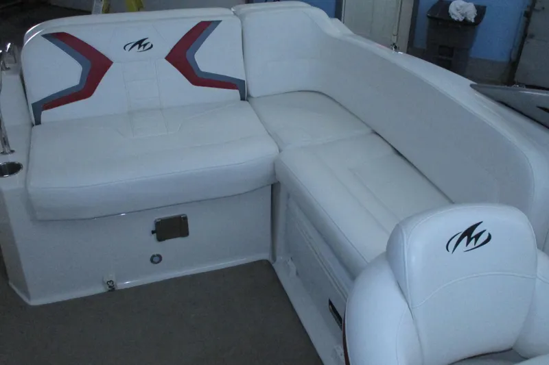 Slide: The Image of 2011 Monterey M3 Sport Boat interior with white cushioned seating and logo detailing. - 4