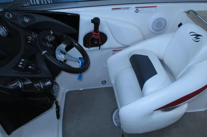 Slide: The Image of Interior of a 2011 Monterey M3 Sport Boat with steering wheel and white captain's chair. - 6
