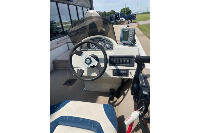 Slide: The Image of 2007 Duracraft 188dlx boat dashboard with steering wheel and control panel. - 5