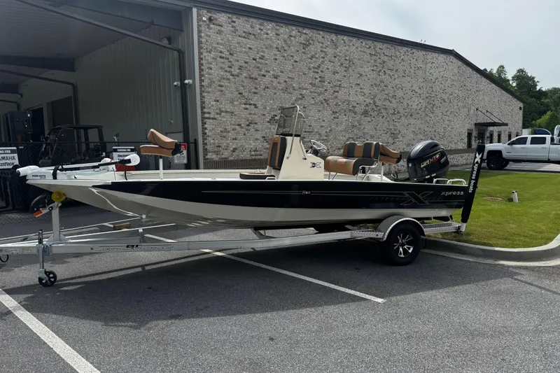 The Image of 2026 Xpress H20B Bay boat on trailer outside a building. - 0