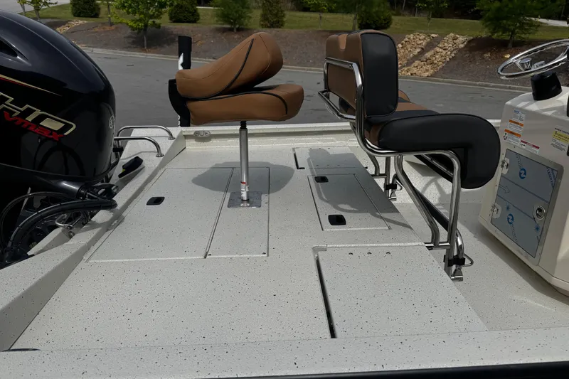 Slide: The Image of 2026 Xpress H20B Bay boat interior with seating and motor detail. - 14