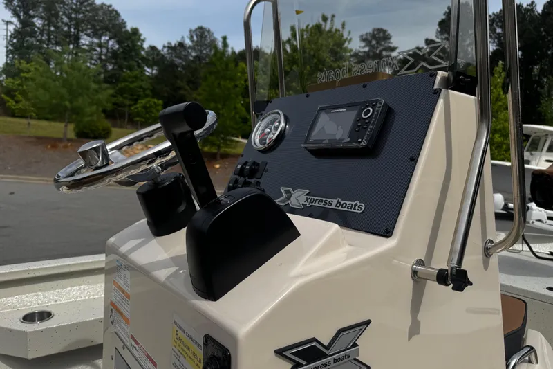 Slide: The Image of 2026 Xpress H20B Bay boat console with steering wheel and navigation system. - 15