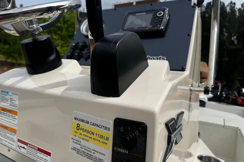 Slide: The Image of 2026 Xpress H20B Bay boat console with Yamaha controls and capacity label. - 16