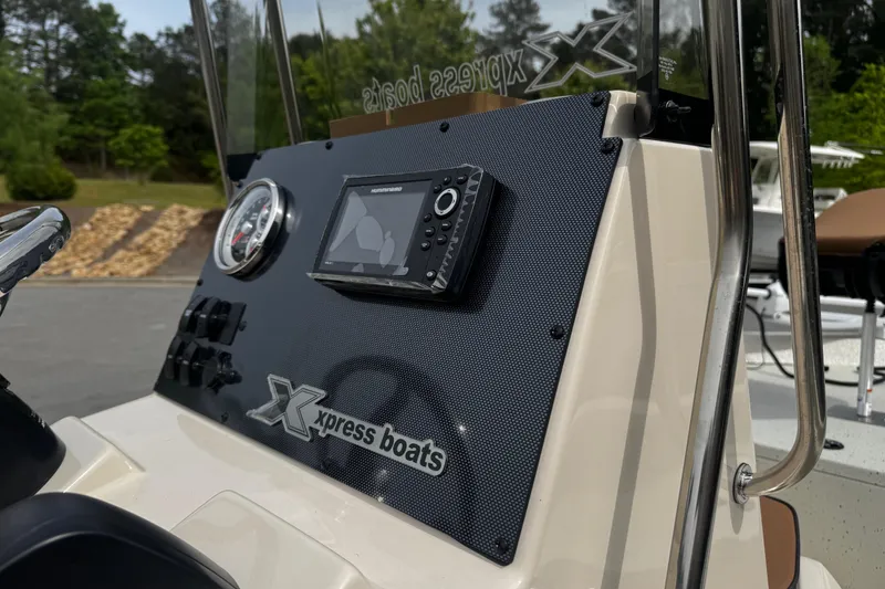 Slide: The Image of 2026 Xpress H20B Bay boat dashboard with navigation system and controls. - 17