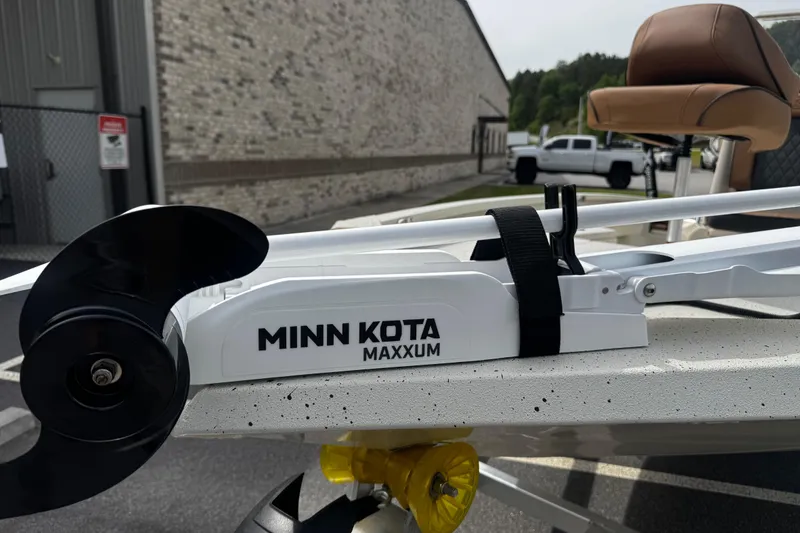 Slide: The Image of Minn Kota Maxxum motor on 2026 Xpress H20B Bay boat, parked outdoors. - 3