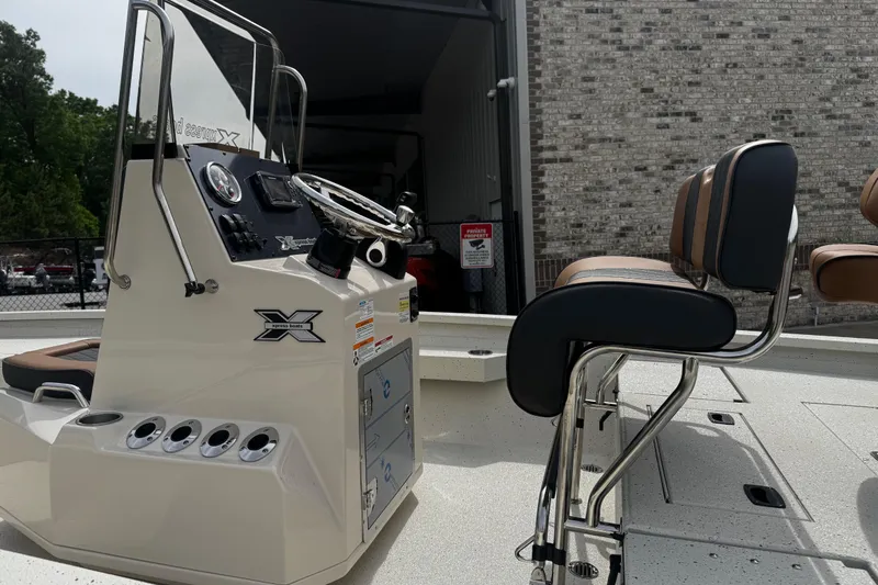Slide: The Image of 2026 Xpress H20B Bay boat interior with steering console and seating. - 8