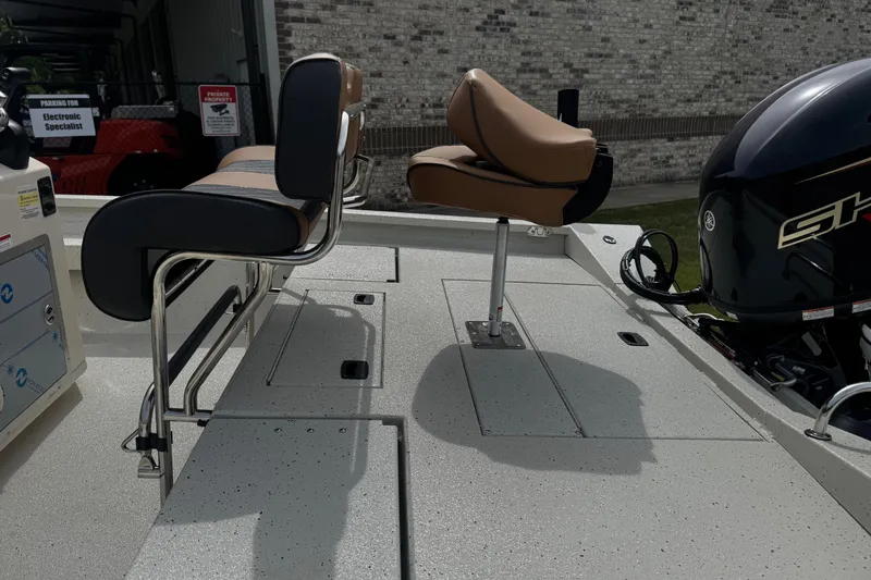Slide: The Image of 2026 Xpress H20B Bay boat interior with seating and motor detail. - 9