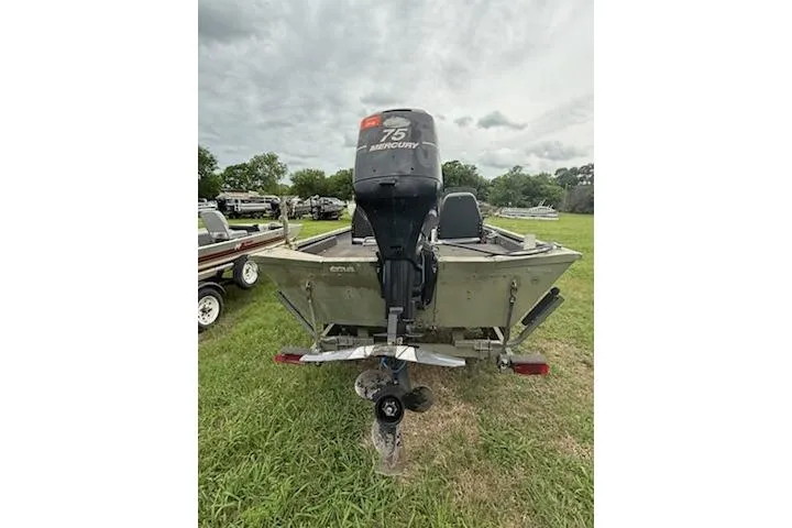 Slide: The Image of 2005 Fisher 1754 AWL boat with Mercury 75 engine on grassy field. - 10