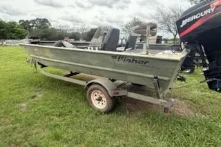 Slide: The Image of 2005 Fisher 1754 AWL boat on trailer with Mercury outboard motor, parked on grass. - 3