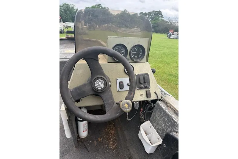 Slide: The Image of 2005 Fisher 1754 AWL boat dashboard with steering wheel and gauges. - 6
