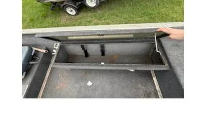 Slide: The Image of 2005 Fisher 1754 AWL boat interior storage compartment with open lid, showing spacious design. - 8