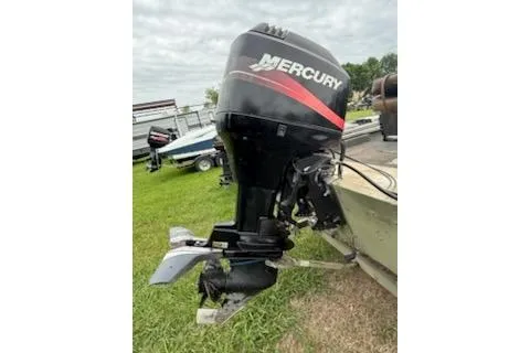 Slide: The Image of 2005 Fisher 1754 AWL boat with Mercury outboard motor on grassy area. - 9