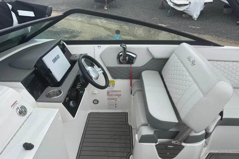 Slide: The Image of 2024 Sea Ray SDX 250 Outboard helm with modern controls and seating. - 10