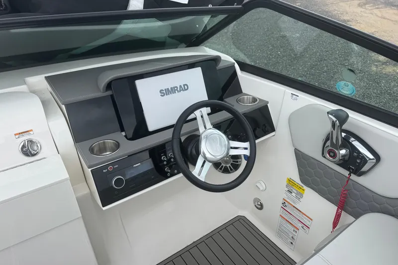 Slide: The Image of 2024 Sea Ray SDX 250 Outboard helm with Simrad display and modern controls. - 11