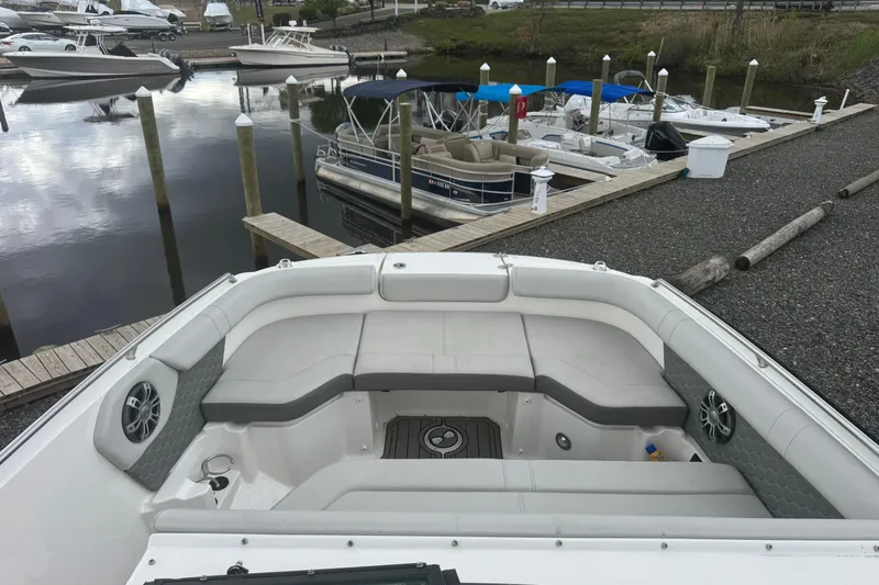 Slide: The Image of 2024 Sea Ray SDX 250 Outboard boat docked, featuring spacious seating and modern design. - 16