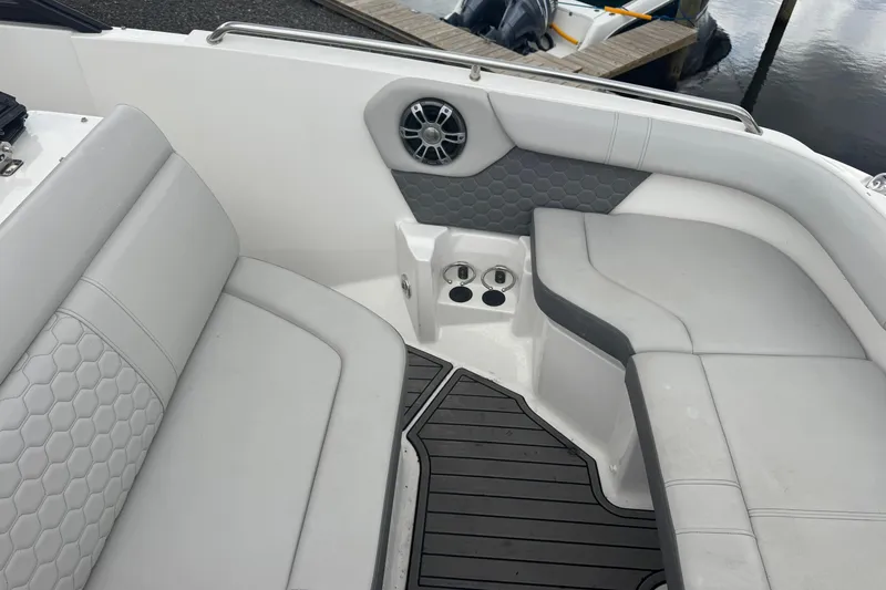 Slide: The Image of 2024 Sea Ray SDX 250 Outboard interior with gray seating and cup holders. - 19