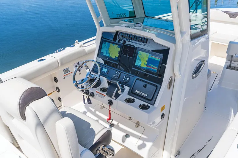 Slide: The Image of Manufacturer Provided Image: 2026 Sailfish 272 CC boat cockpit with advanced navigation systems and steering wheel. - 4