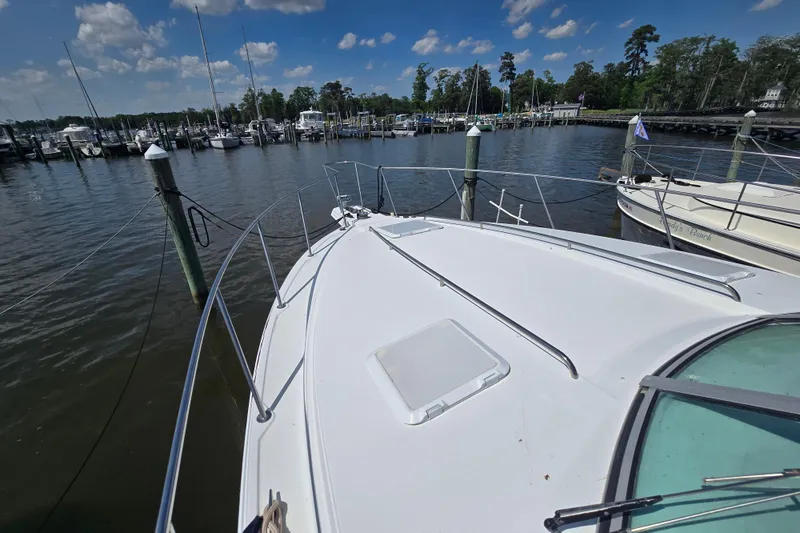 Slide: The Image of 1997 Formula 34 Performance Cruiser docked at a marina under a clear blue sky. - 10