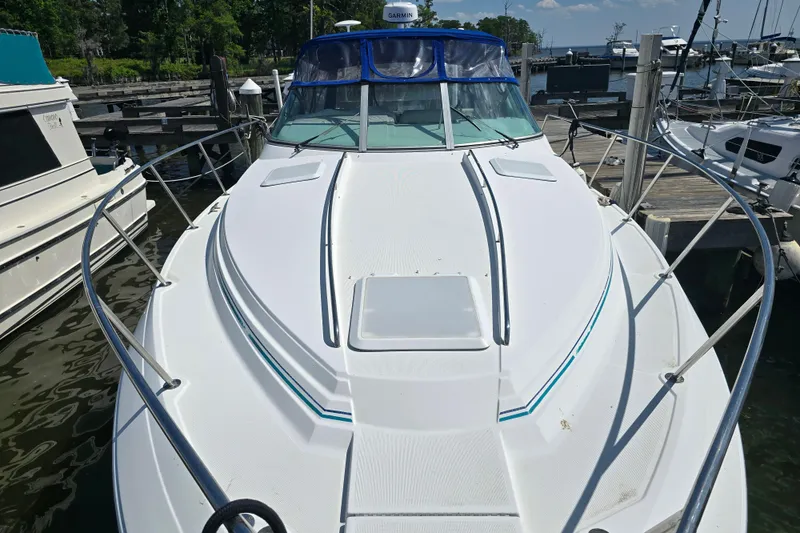 Slide: The Image of 1997 Formula 34 Performance Cruiser docked at marina, showcasing sleek design and spacious deck. - 11