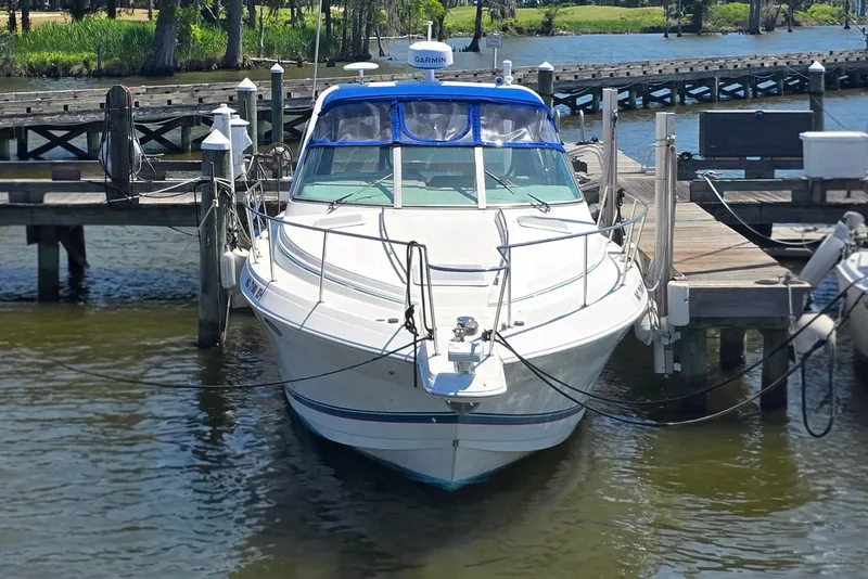 Slide: The Image of 1997 Formula 34 Performance Cruiser docked at a marina, front view. - 12