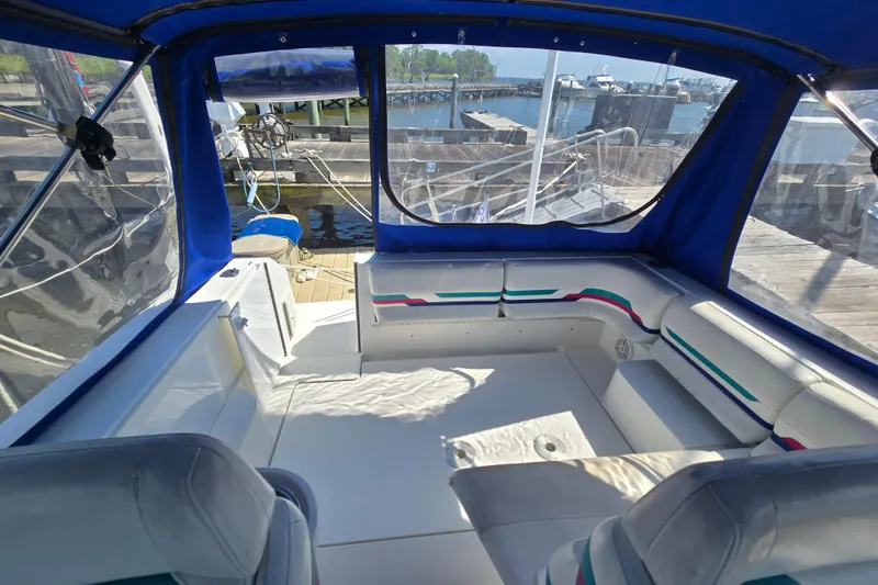 Slide: The Image of Interior view of a 1997 Formula 34 Performance Cruiser with blue canopy and white seating. - 14