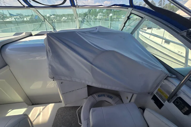 Slide: The Image of 1997 Formula 34 Performance Cruiser cockpit with covered controls and marina view. - 18