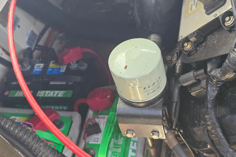 Slide: The Image of Engine compartment of a 1997 Formula 34 Performance Cruiser with visible battery and oil filter. - 23