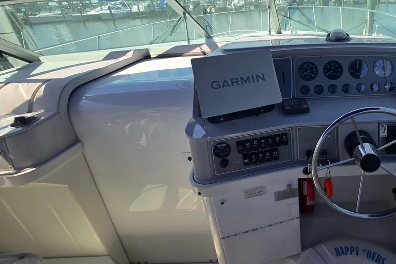Slide: The Image of 1997 Formula 34 Performance Cruiser cockpit with Garmin navigation system and steering wheel. - 24