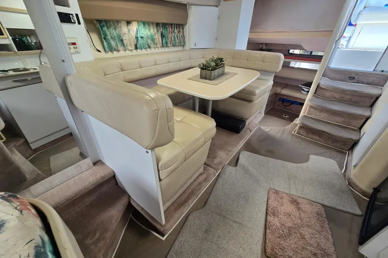 Slide: The Image of Interior of a 1997 Formula 34 Performance Cruiser with beige seating and dining area. - 25