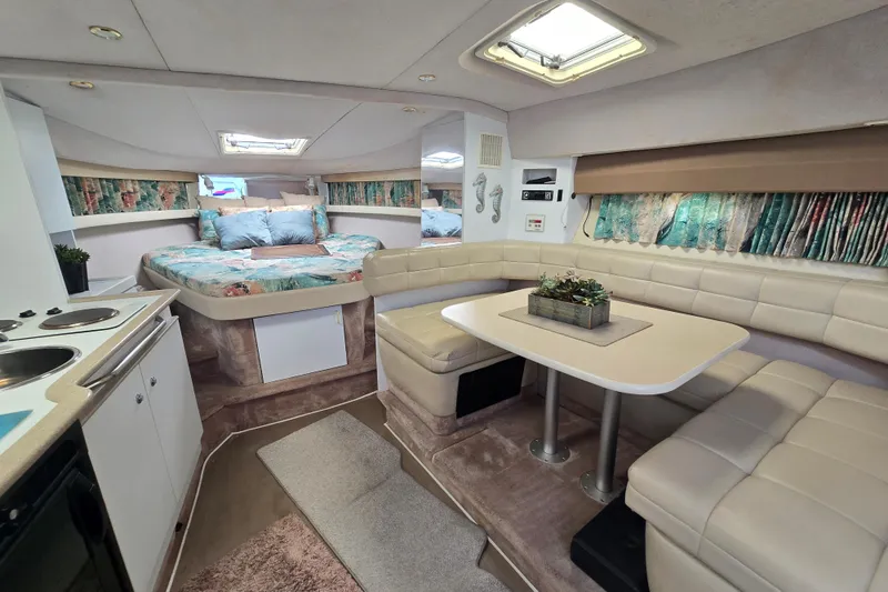 Slide: The Image of Interior of a 1997 Formula 34 Performance Cruiser with cozy seating and a compact kitchen. - 26