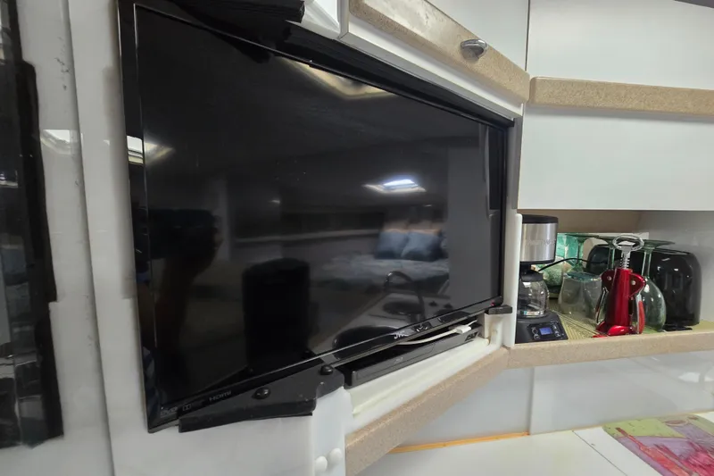 Slide: The Image of Interior of 1997 Formula 34 Performance Cruiser with TV and kitchen appliances. - 29