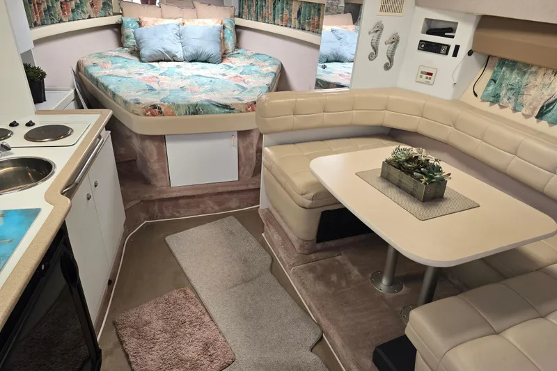 Slide: The Image of Interior of a 1997 Formula 34 Performance Cruiser with cozy seating and kitchenette. - 32