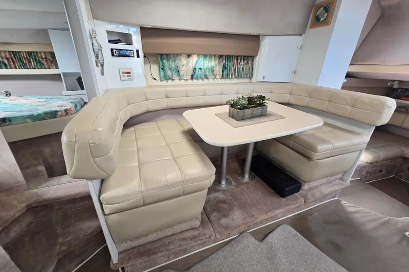 Slide: The Image of Interior of a 1997 Formula 34 Performance Cruiser with beige seating and table. - 33