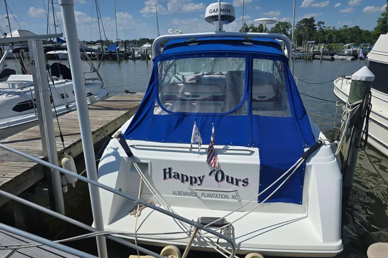 Slide: The Image of 1997 Formula 34 Performance Cruiser docked at marina with blue canopy. - 4