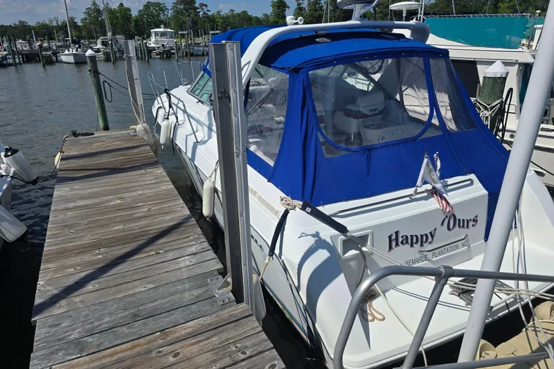 Slide: The Image of 1997 Formula 34 Performance Cruiser docked with blue canopy and wooden pier. - 6