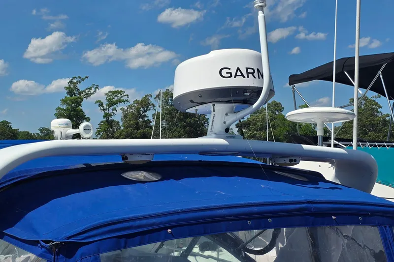 Slide: The Image of 1997 Formula 34 Performance Cruiser with Garmin radar, blue canopy, and clear sky background. - 9
