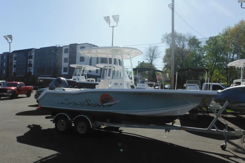The Image of 2024 Tidewater 210 LXF boat on trailer in outdoor dealership lot. - 0