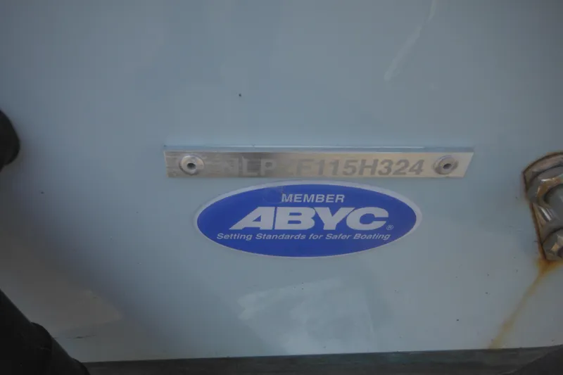 Slide: The Image of 2024 Tidewater 210 LXF boat with ABYC member sticker and hull identification number. - 4