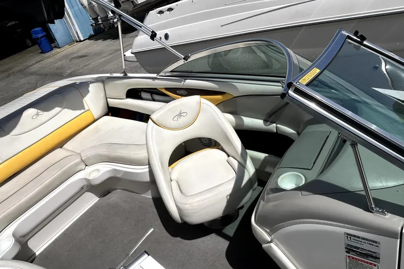 Slide: The Image of 2003 Monterey 218LS Montura Bowrider interior with white and yellow seating. - 17